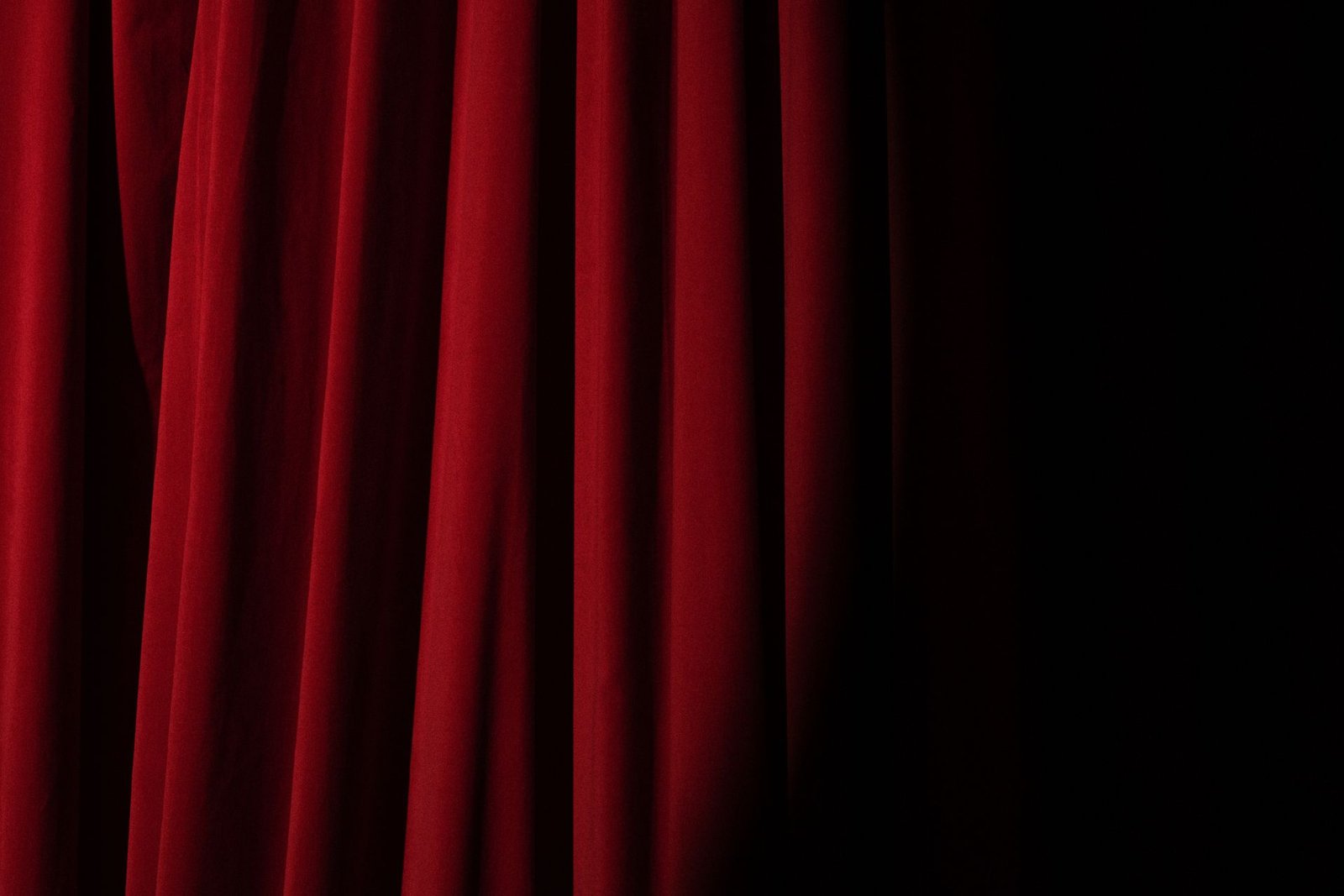 Projecteur sur un rideau de théâtre rouge